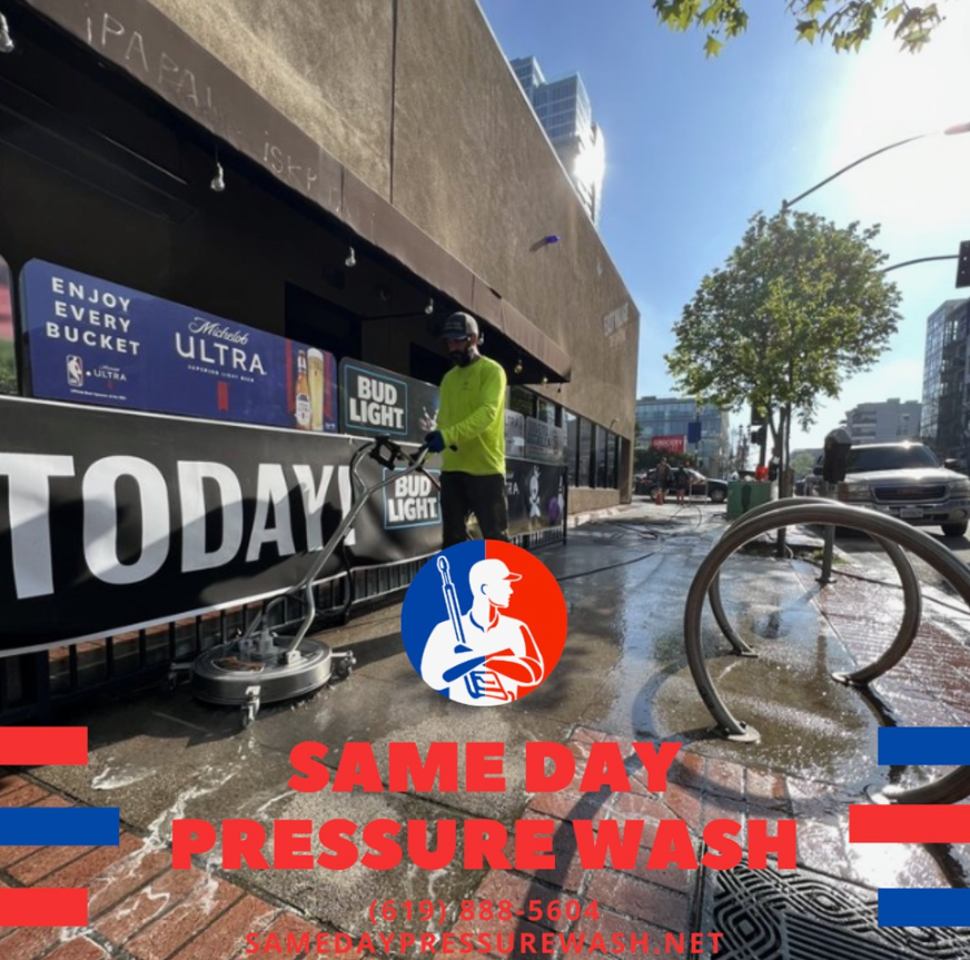 Same Day Pressure Wash crew cleaning a storefront sidewalk in downtown San Diego