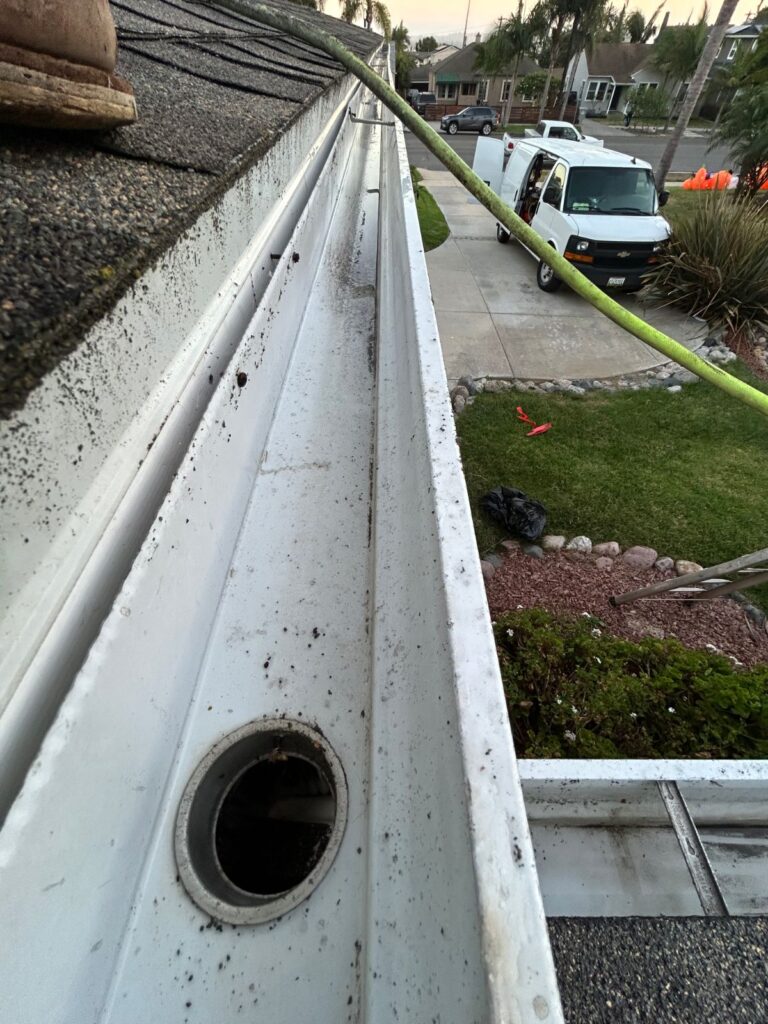 Clean gutter and downspout opening