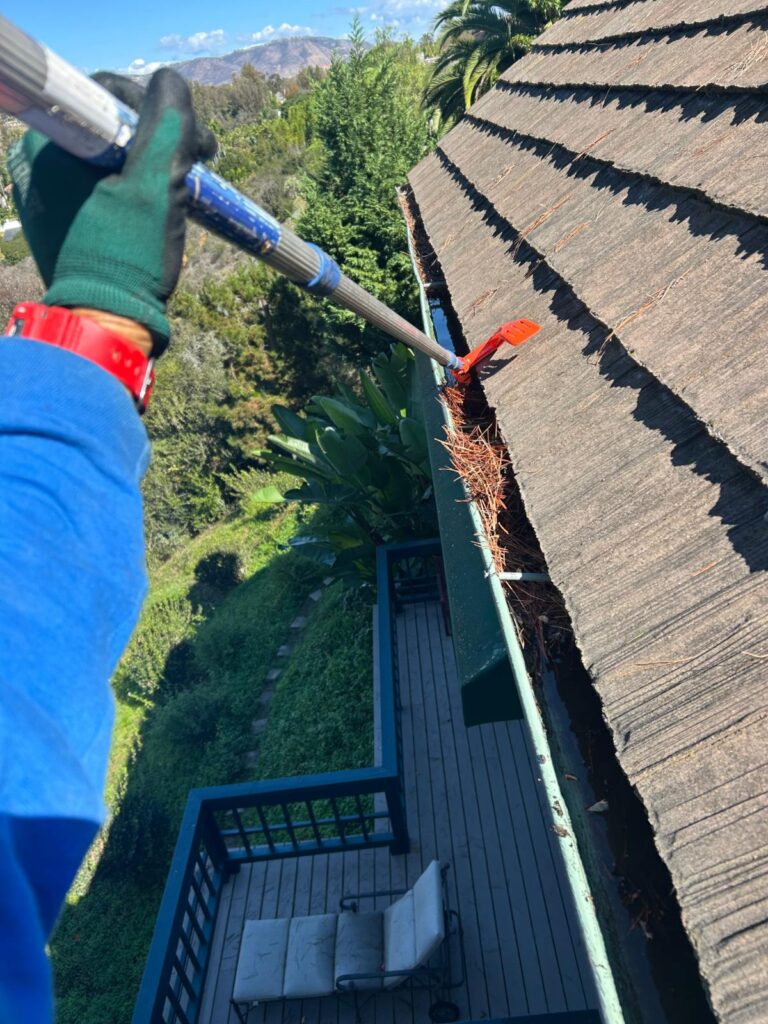 Gutter cleaning on a hillside home in San Diego