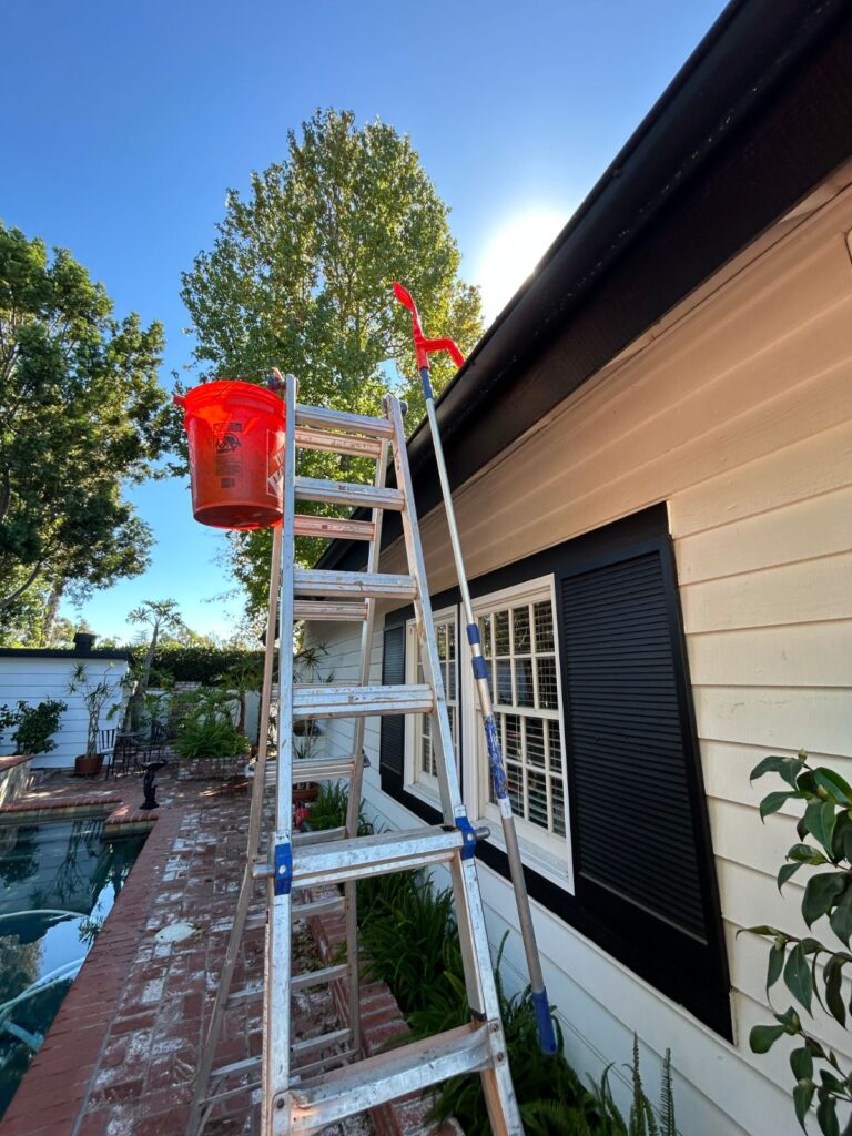 Ladder set up for gutter cleaning on a two story home in San Diego